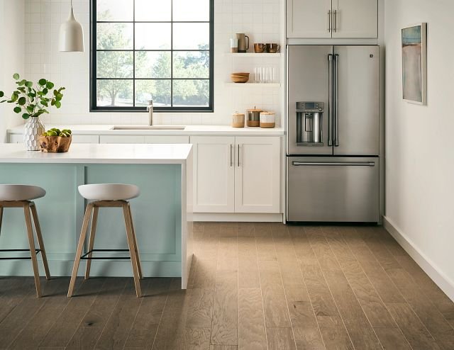 large modern kitchen with white bar top and bar stools from Richardson’s Carpet Service in the Williamsburg, VA area